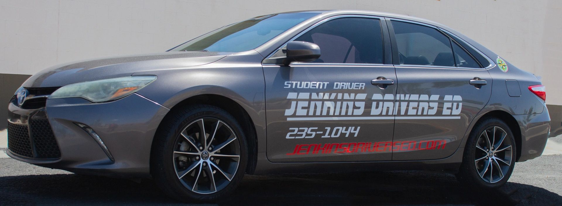 Silver Toyota Camry training vehicle with Jenkins Drivers Ed branding